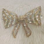 Crystal embellished luxury hair bow clip with rhinestones and pearl detailing for bridal and party wear hairstyles