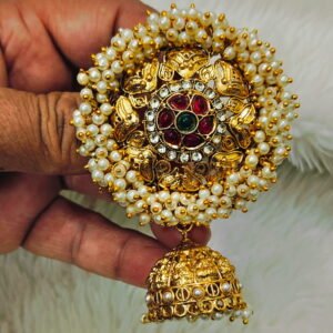 Traditional South Indian gold-finish Jada Billalu hair accessory with pearl detailing and red-green stone embellishments for bridal hairstyles